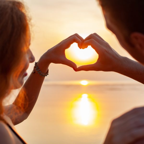 young-sexy-romantic-couple-love-happy-summer-beach-together-having-fun-wearing-swim-suits-showing-heart-sign-sundet
